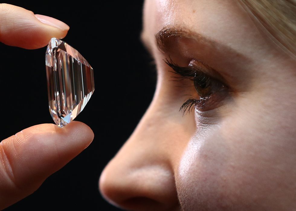 Woman examines a diamond.