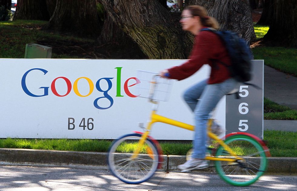 A cyclist pedals past the Google headquarters.