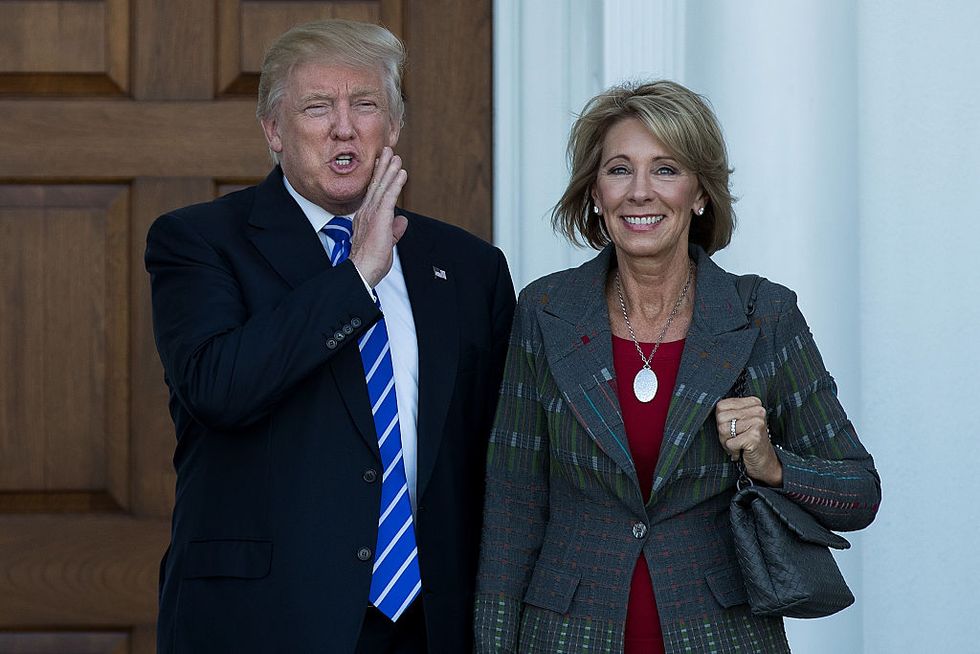 President Donald Trump and Betsy DeVos pose for a photo after their meeting at Trump International Golf Club, November 19, 2016 in Bedminster Township, New Jersey. (Photo by Drew Angerer/Getty Images)