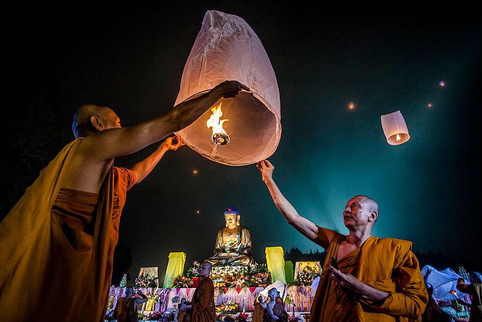 Buddhist monks release a lantern into the air at Borobudur temple during celebrations for Vesak Day. The holy day celebrates the birth, the enlightenment to nirvana, and the passing of Gautama Buddha's, the founder of Buddhism.