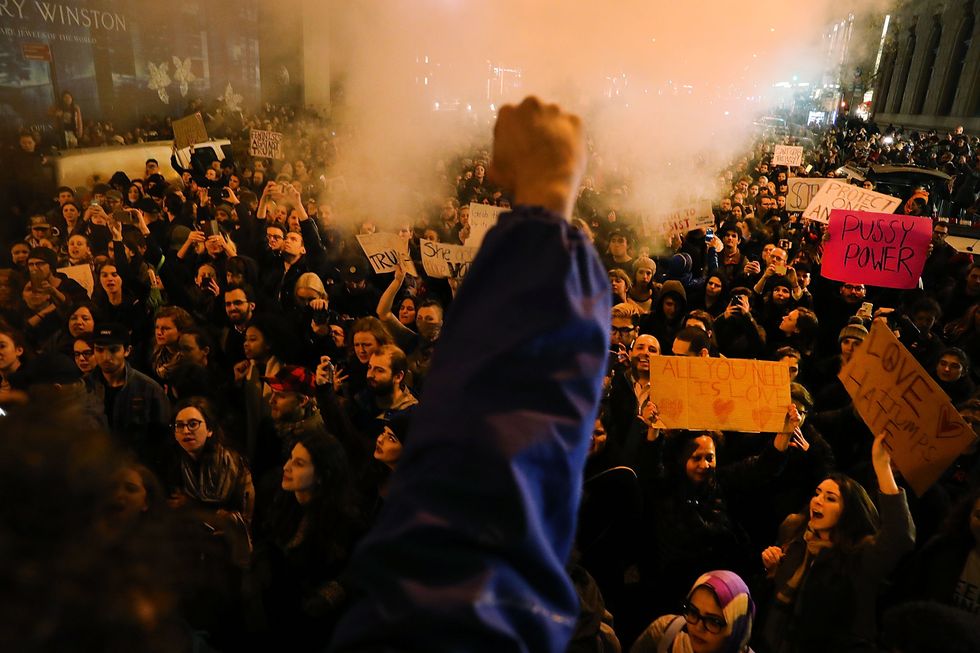 A protestor raises his fist in a power/defiance gesture during the protests that followed the 2016 US election results.