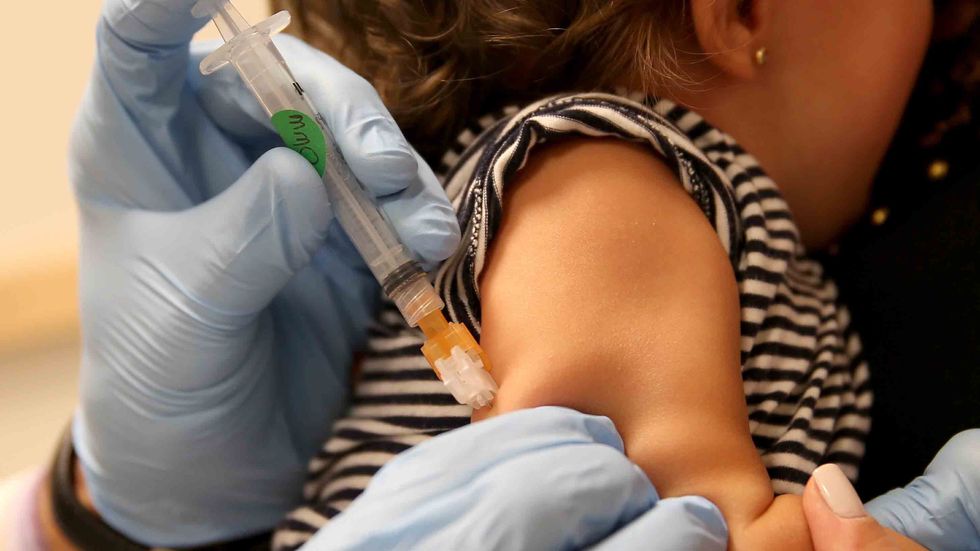 A children's doctor injects a vaccine against measles, rubella, mumps and chicken pox to an infant on February 26, 2015 in Berlin, Germany. (Sean Gallup/Getty Images)