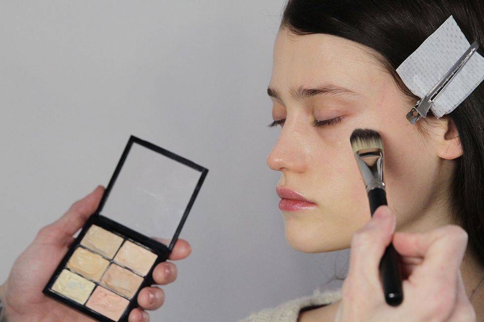 Woman getting made up.