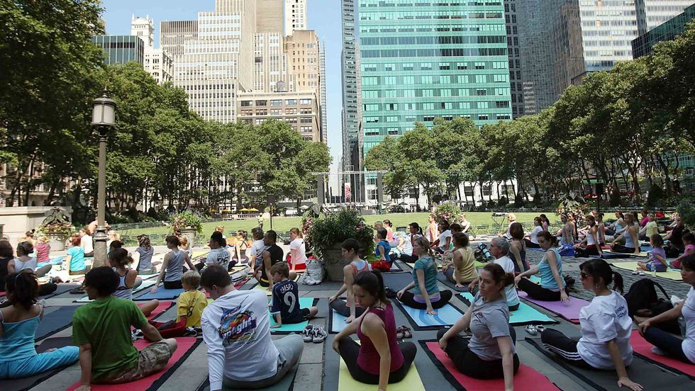 People participate in a free outdoor yoga class in Bryant Park in New York City. (Spencer Platt/Getty Images)