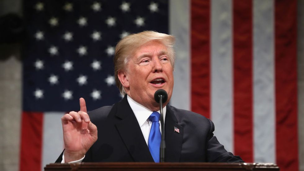 US President Donald Trump gestures during the State of the Union address in the chamber of the US House of Representatives in Washington, DC, on January 30, 2018. (Photo: Win McNamee/AFP/Getty Images)