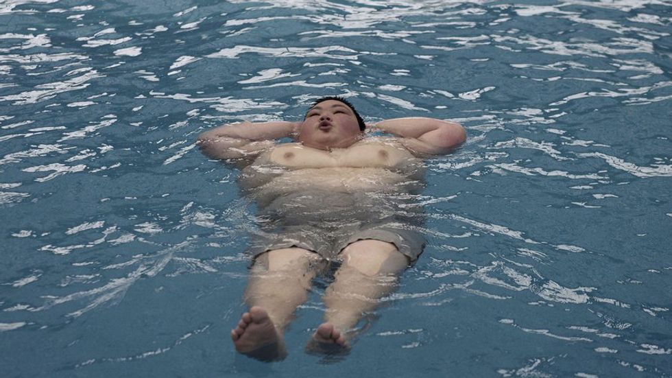 Huang Jiaxin, 15 years old, performs weight loss exercises at the Aimin Slimming Centre. (Photo by China Photos/Getty Images)