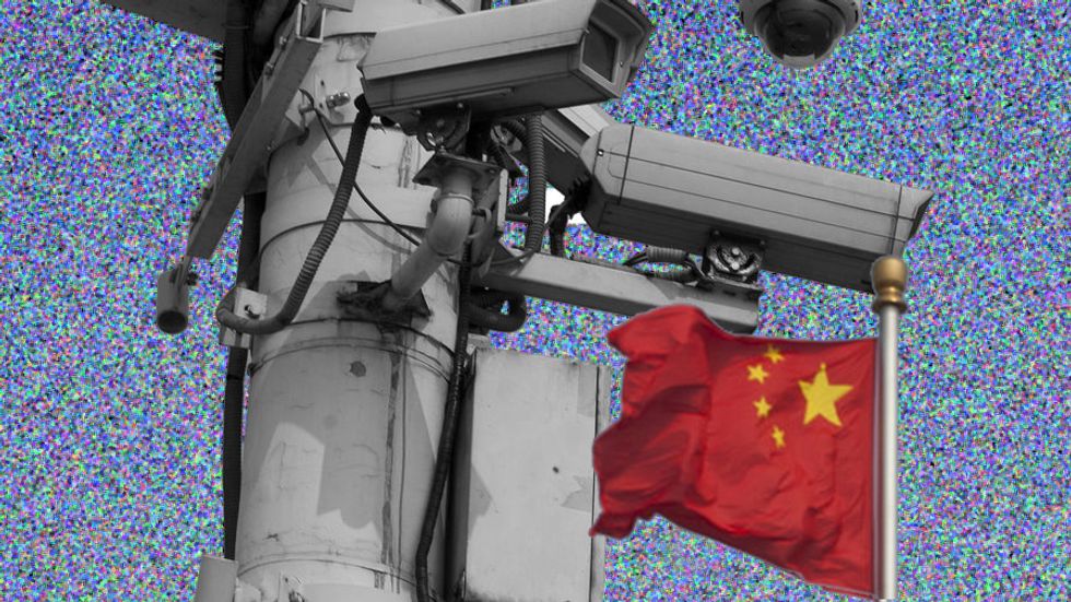 The Chinese national flag flies behind security cameras on Tiananmen Square. (Photo: Ed Jones/AFP/Getty Images)