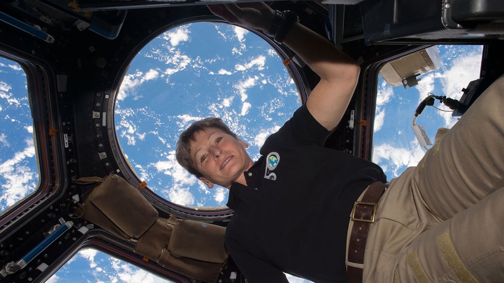 Astronaut Peggy Whitson against the backdrop of earth
