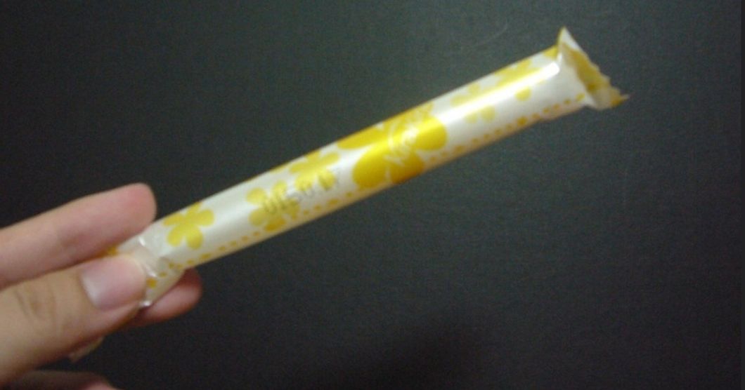 Flickr- Woman holding packaged tampon