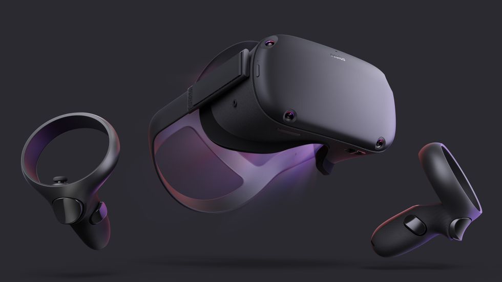 A black and purple virtual reality headset from Oculus with two hand controllers