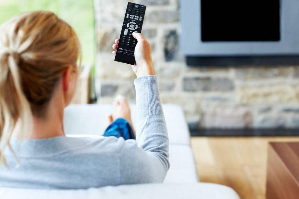 Picture of smart TV and woman with remote control.