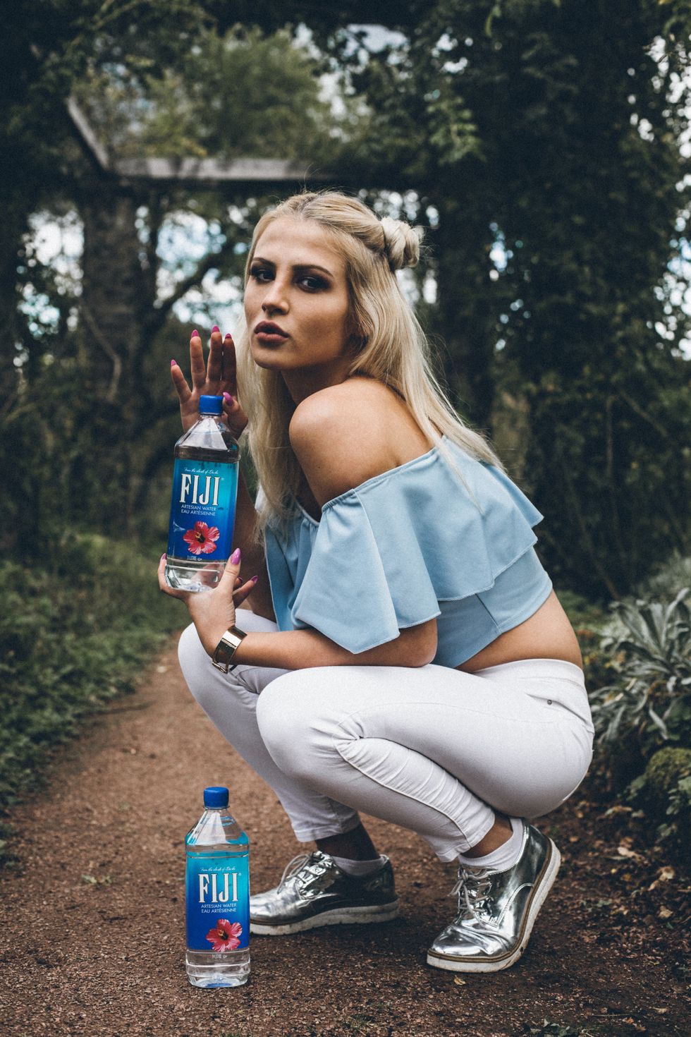 Blonde girl holding a bottle of water