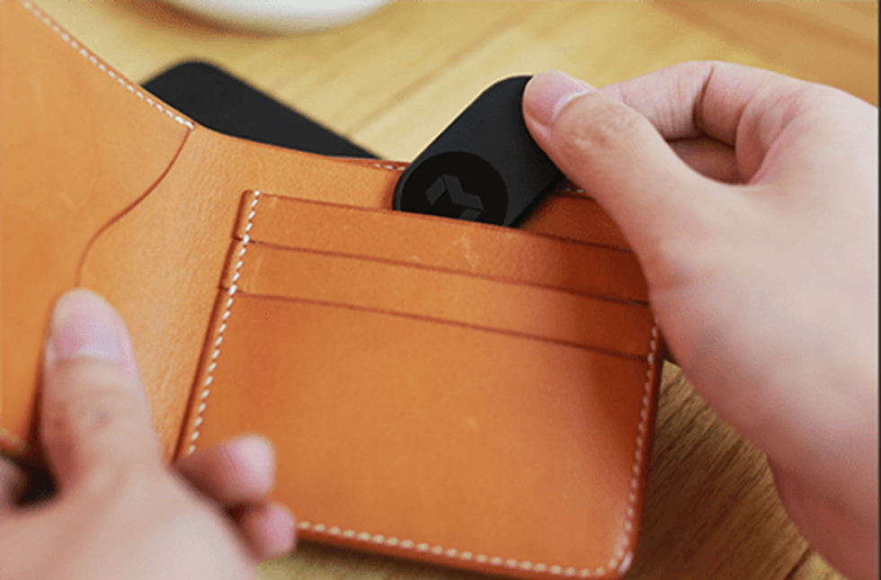 picture of MYNT tracker being inserted into a wallet