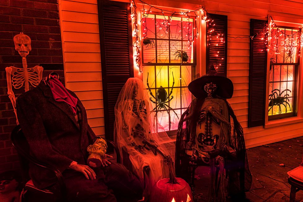 Picture of kids on halloween with motion sensors lighting up front porch.