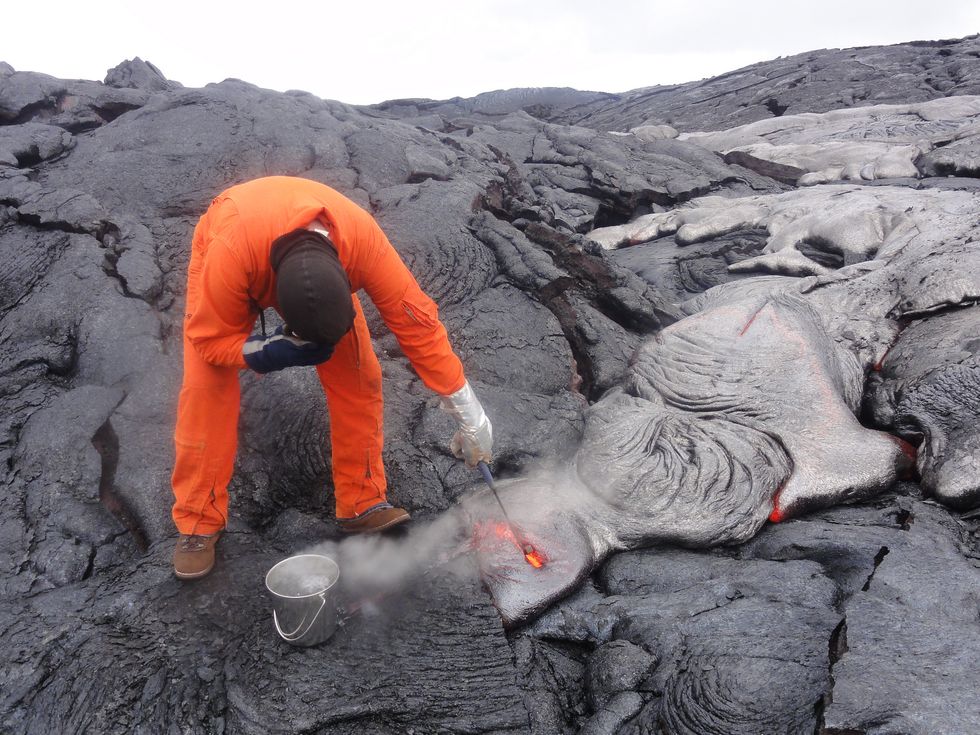 Watch Your Fingers! Geologist on Hawaiian Volcano Collects Lava Samples.