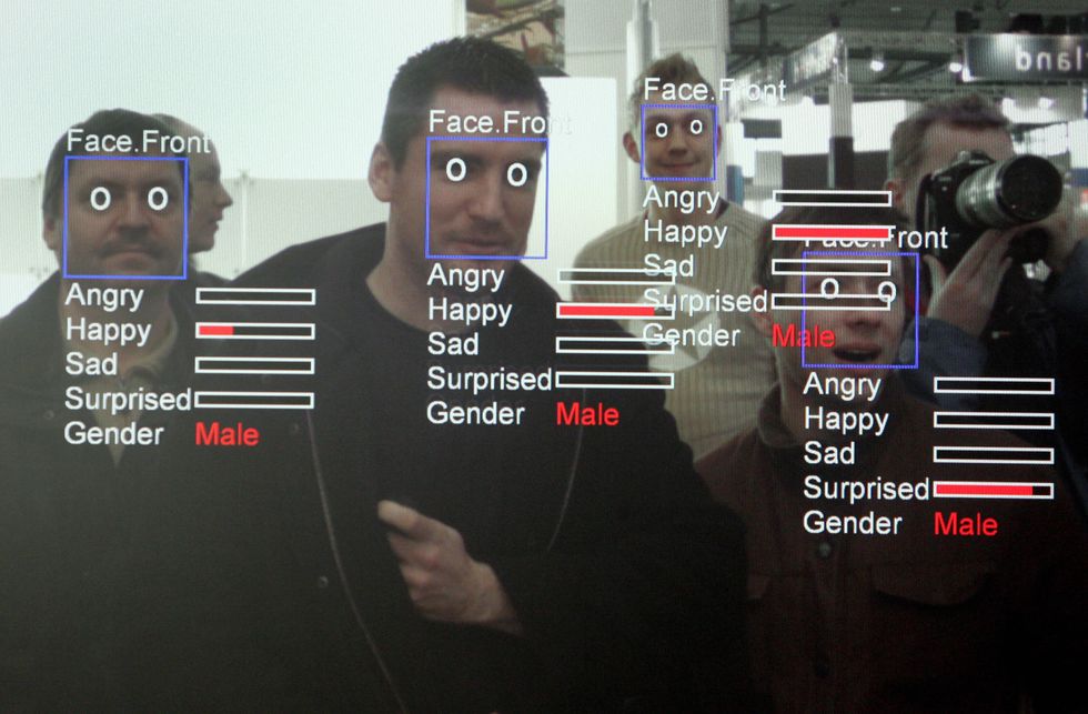 Men being scanned by facial recognition software.