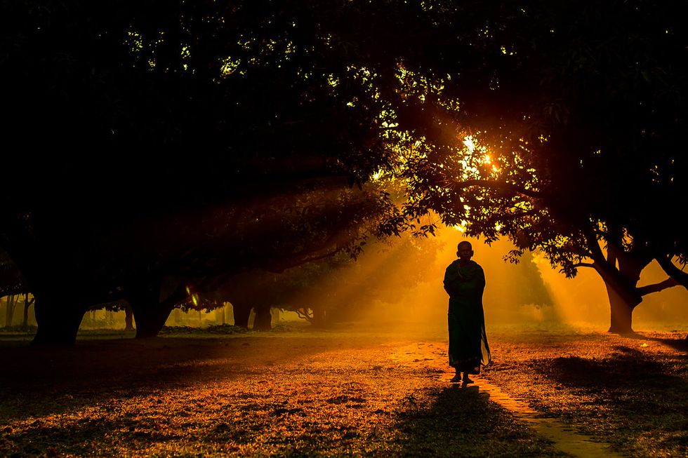 A Hindu monk walking in a mango grove. Dinajpur, Bangladesh.