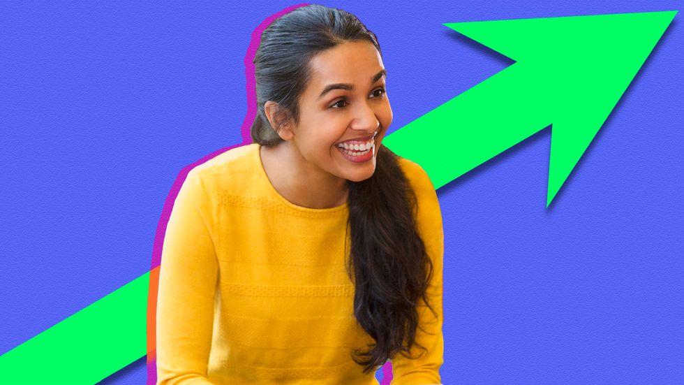 A woman smiling in a meeting at a diverse startup. (Credit: Caiaimage/Sam Edwards/Getty Images/Big Think)