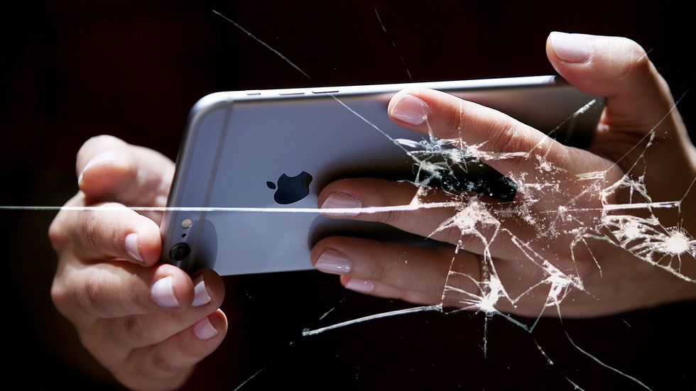 Apple iPhone cracked screen. Nearly every stage in the smartphone life cycle involves something ethically questionable. (Photo by Justin Sullivan/Getty Images)