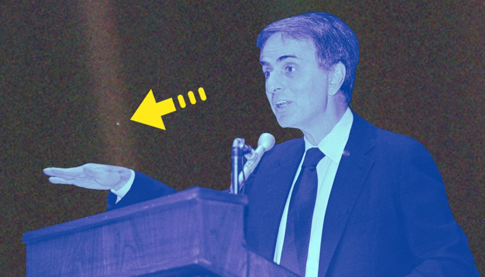 Carl Sagan speaking in 1987, with 'Pale Blue Dot' in the background.