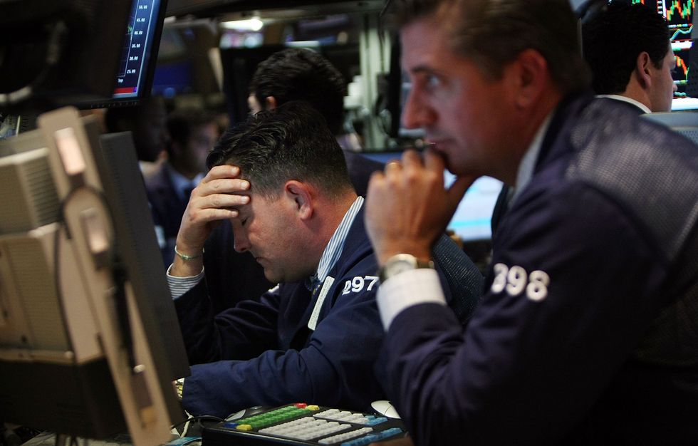 NEW YORK - SEPTEMBER 17: Traders work on the floor of the New York Stock Exchange September 17, 2008 in New York City. The Dow Jones Industrial Average closed down 449 points today despite American International Group, Inc. (AIG) $85 billion government ba