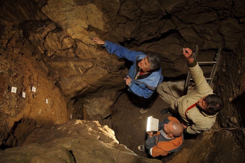 Researchers in a chamber of the Denisova cave in Siberia, where the fossil of a Denisova 11 was discovered. CreditIAET SB RAS, Sergei Zelensky