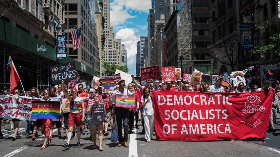 a pride parade featuring a Democratic Socialists of America (DSA) sign