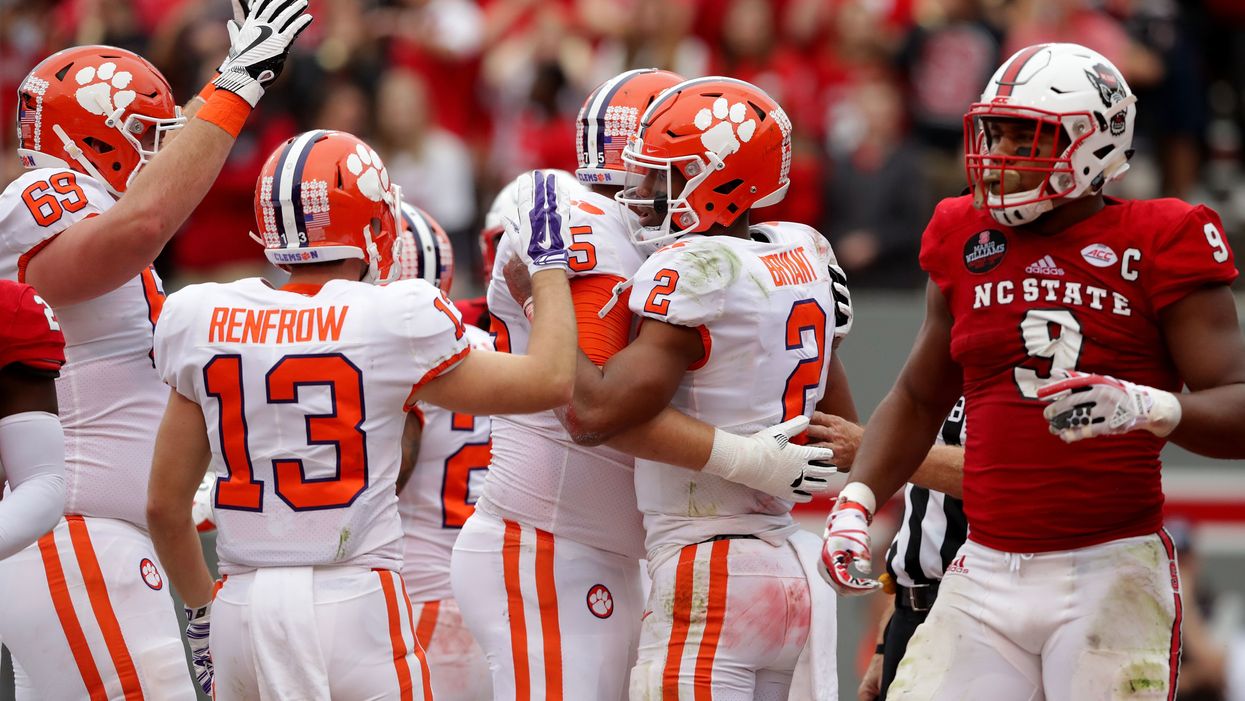 NC State player helps Clemson fan down onto field to celebrate his team's blowout loss
