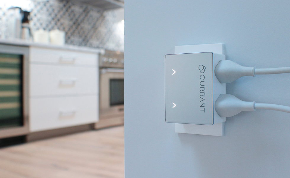 Picture of Currant smart outlet plugged into the wall.