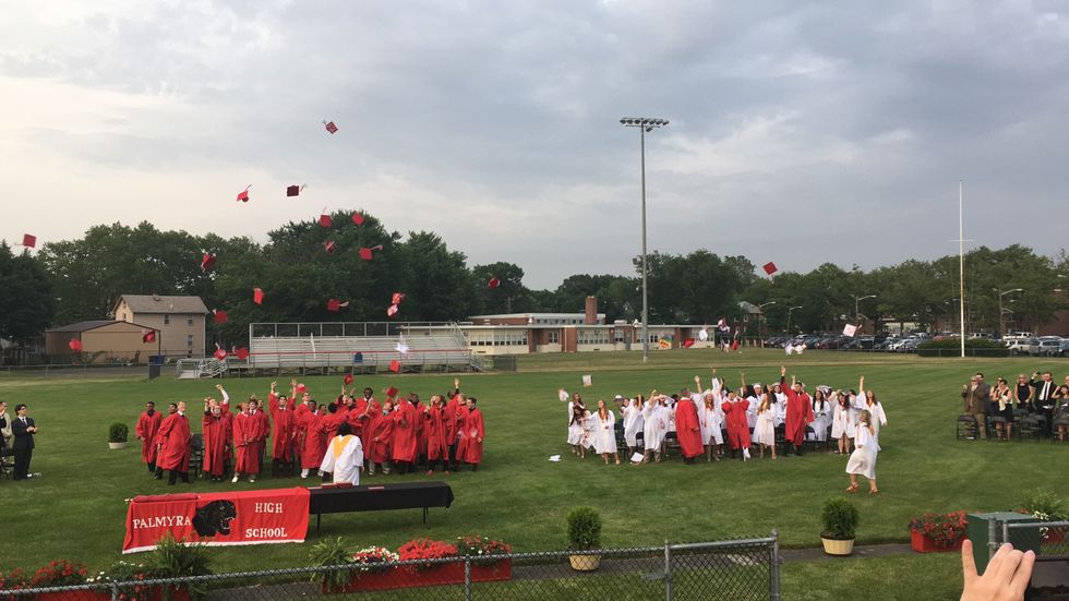 Kids throwing up their graduation caps