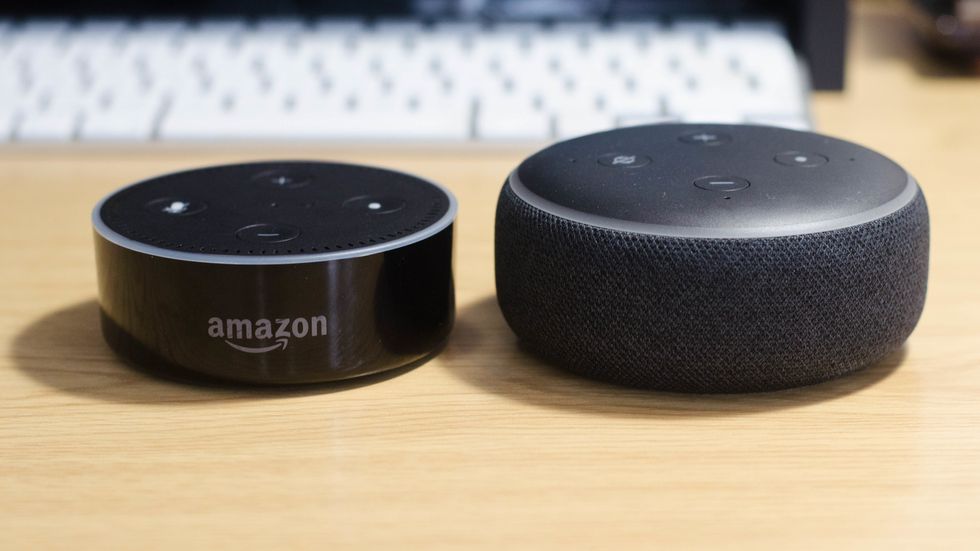 a photo of 1st gen and 2nd gen echo dots