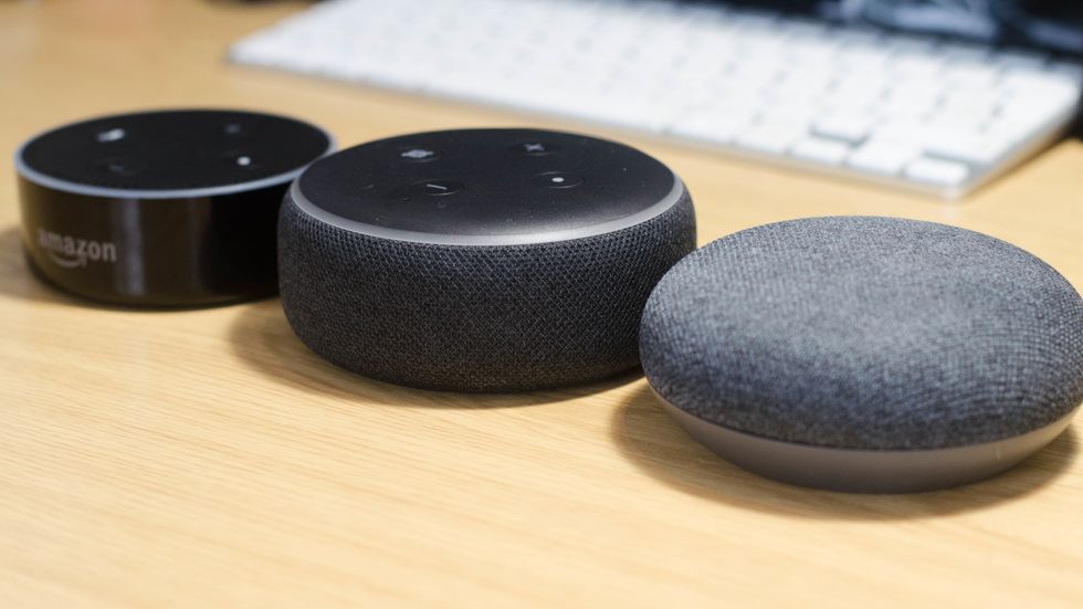 a photo of 1st gen and 2nd gen Echo Dots as well as Google Home Mini