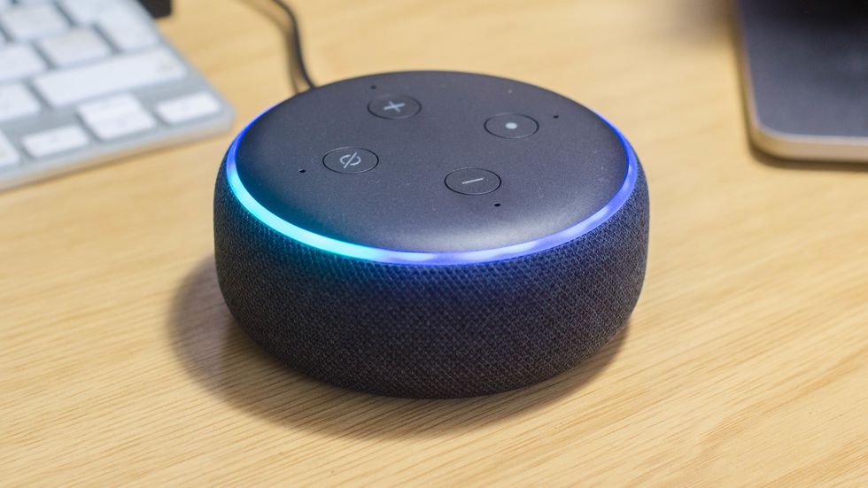 Picture of Echo Dot on a desktop.