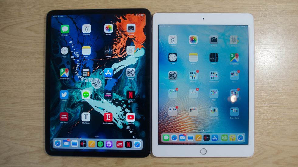 Two iPads on a table, one in black and one in white
