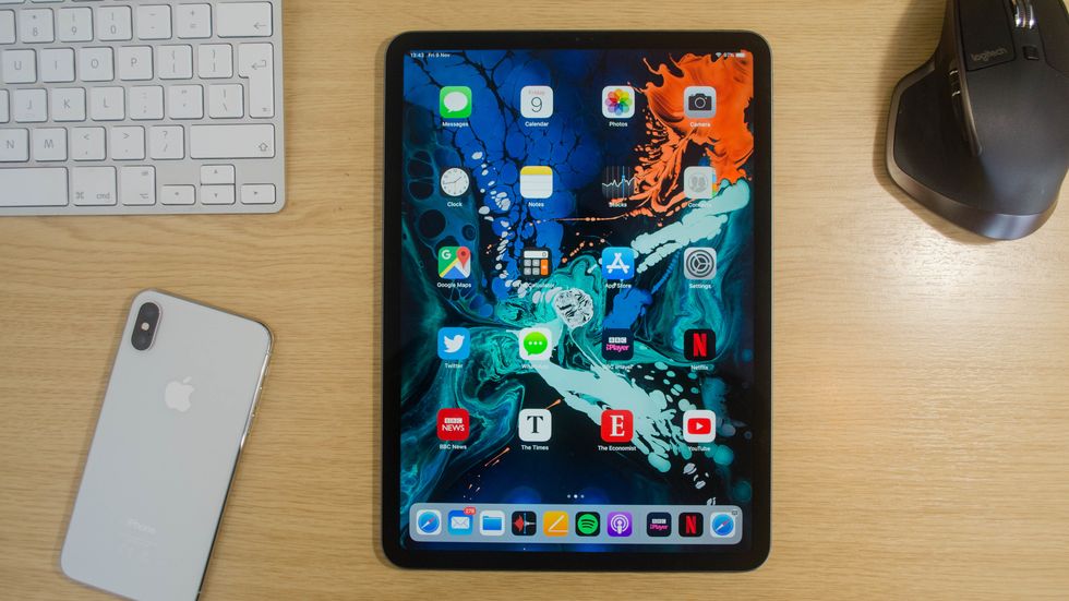 An iPad Pro on a table next to an iPhone