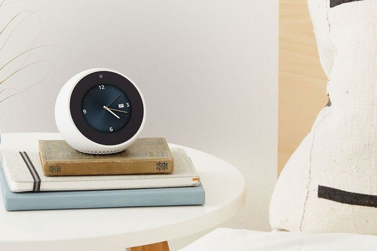 Photo of Echo Spot ontop of books on a nightstand