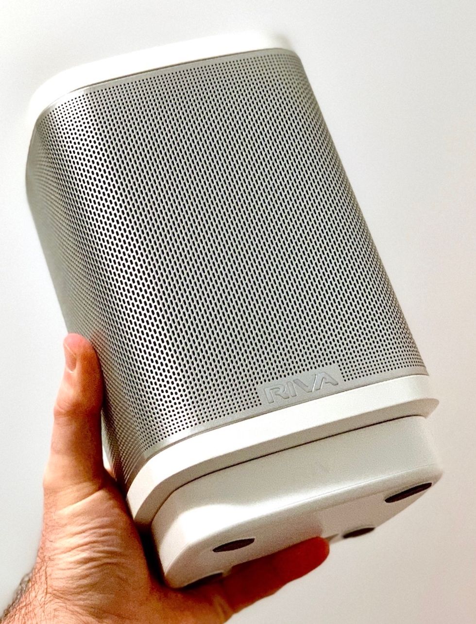 a photo of Riva Concert speaker in a man's hand.