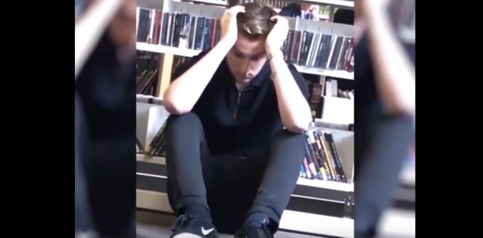 Guy Holding His Head While In Fetal Position