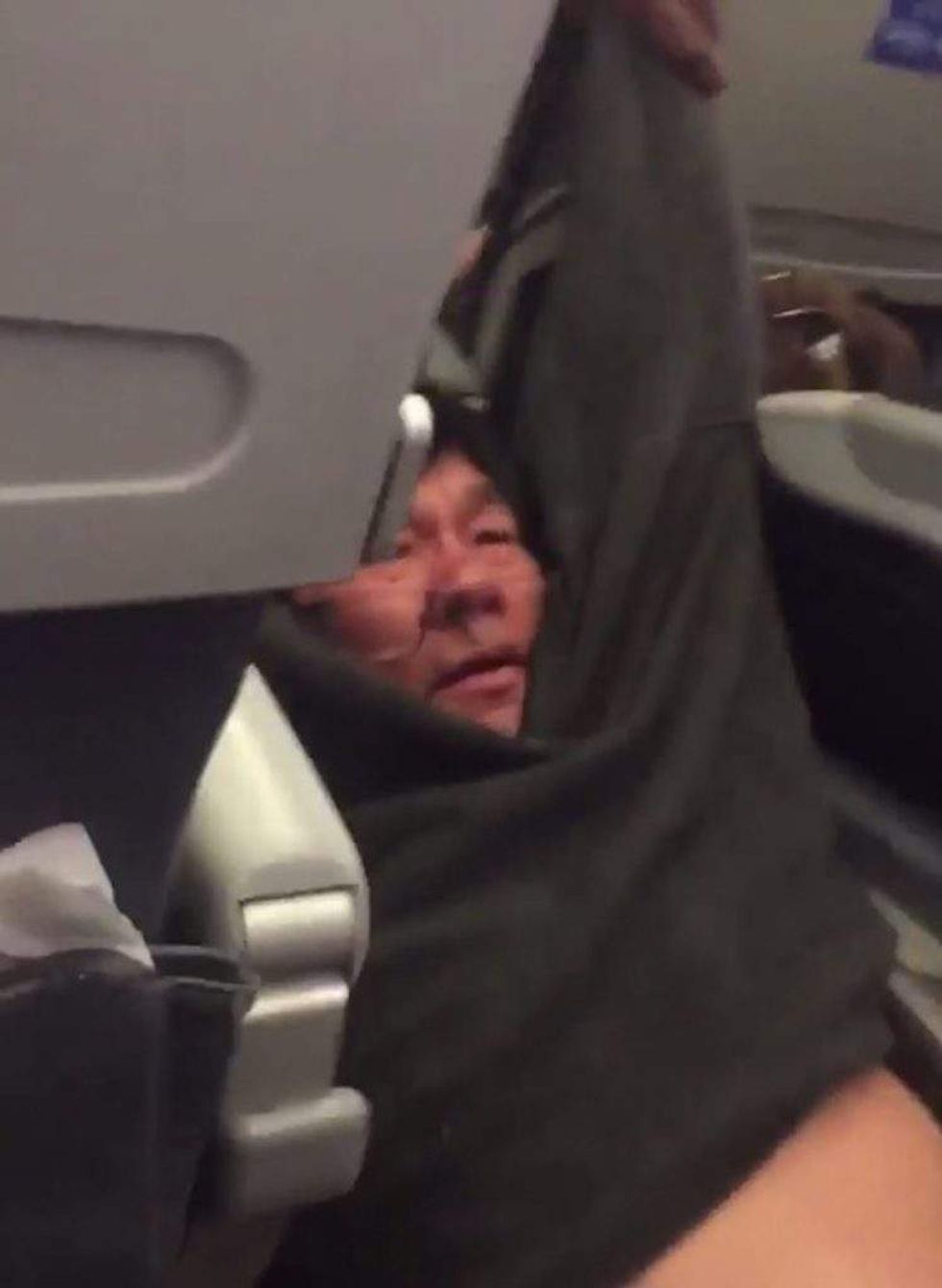 Watch screaming passenger get dragged off plane after airline