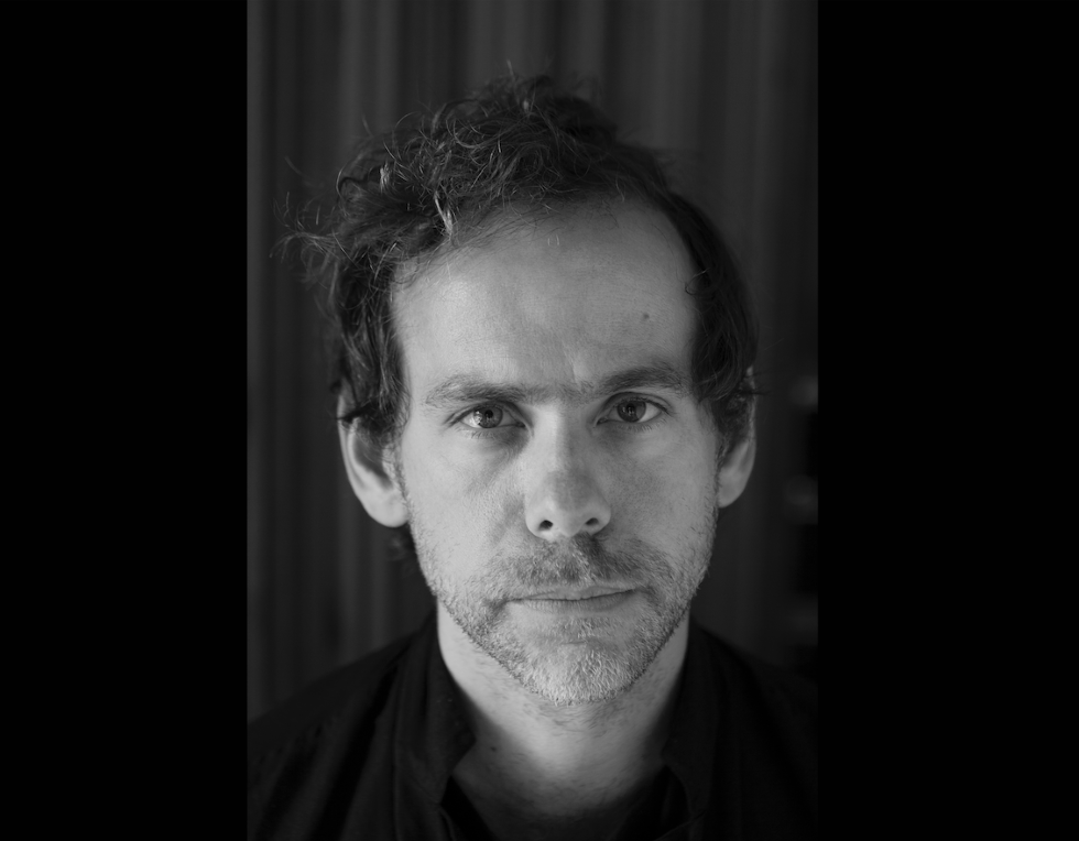 Black and white headshot of guitarist Bryce Dessner