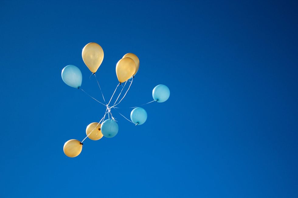 https://www.pexels.com/photo/photo-of-yellow-and-blue-balloons-on-sky-1590915/