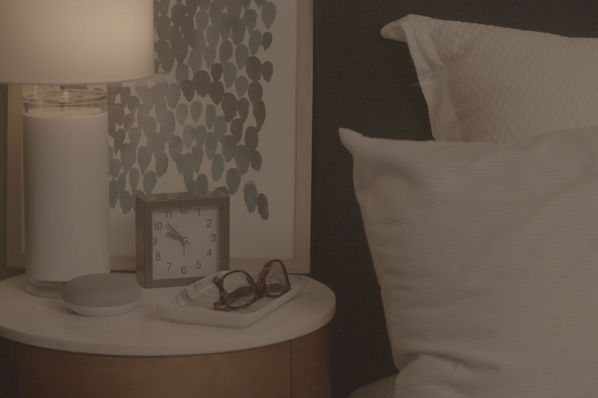 a photo of CbyGE bulbs in a lamp on a nightstand.