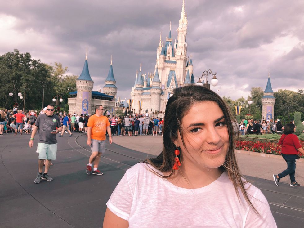 Girl standing in front of Disney castle