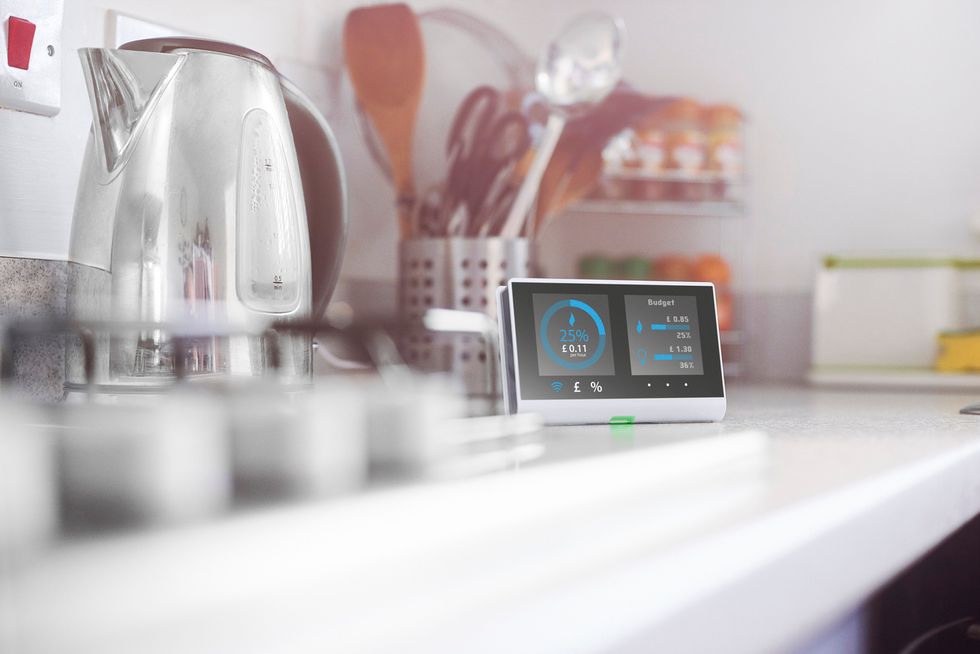 a photo of a kitchen with a smart display on the counter.