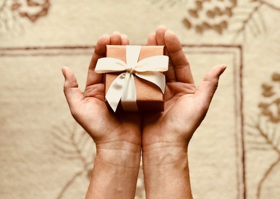 https://www.pexels.com/photo/person-s-holds-brown-gift-box-842876/