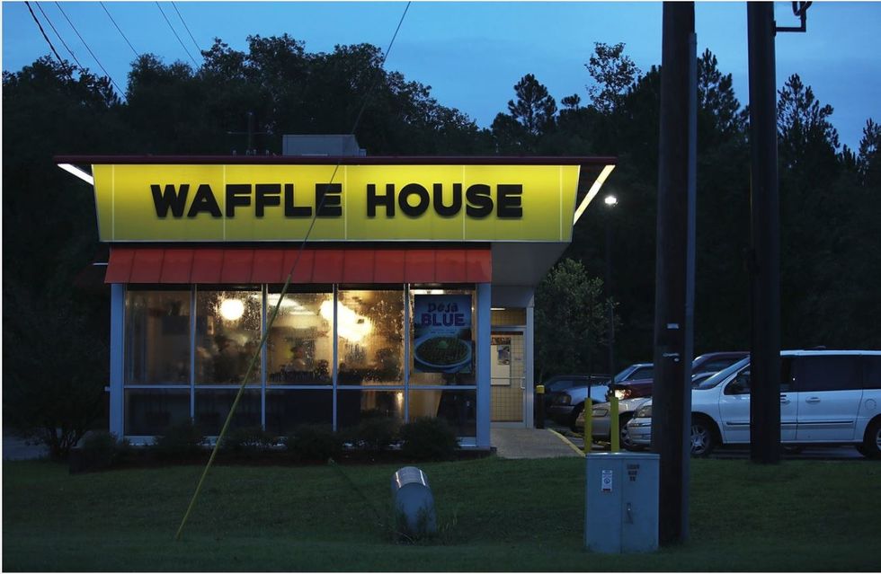 An exterior of a Waffle House at night