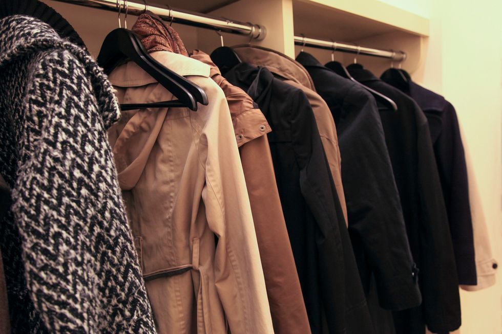 \u200bA collection of coats hanging in a coat room