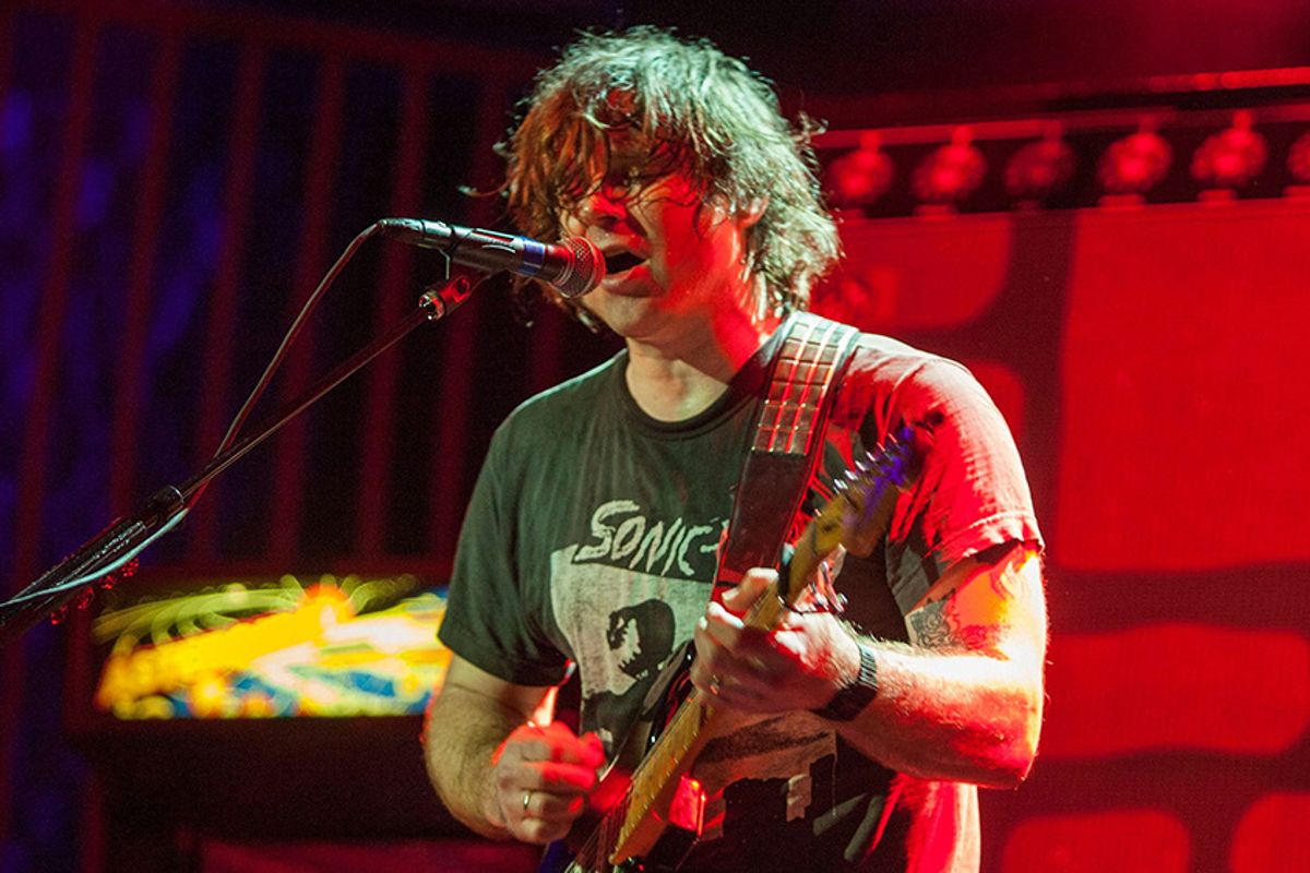 Ryan adams covered in sweat playing guitar