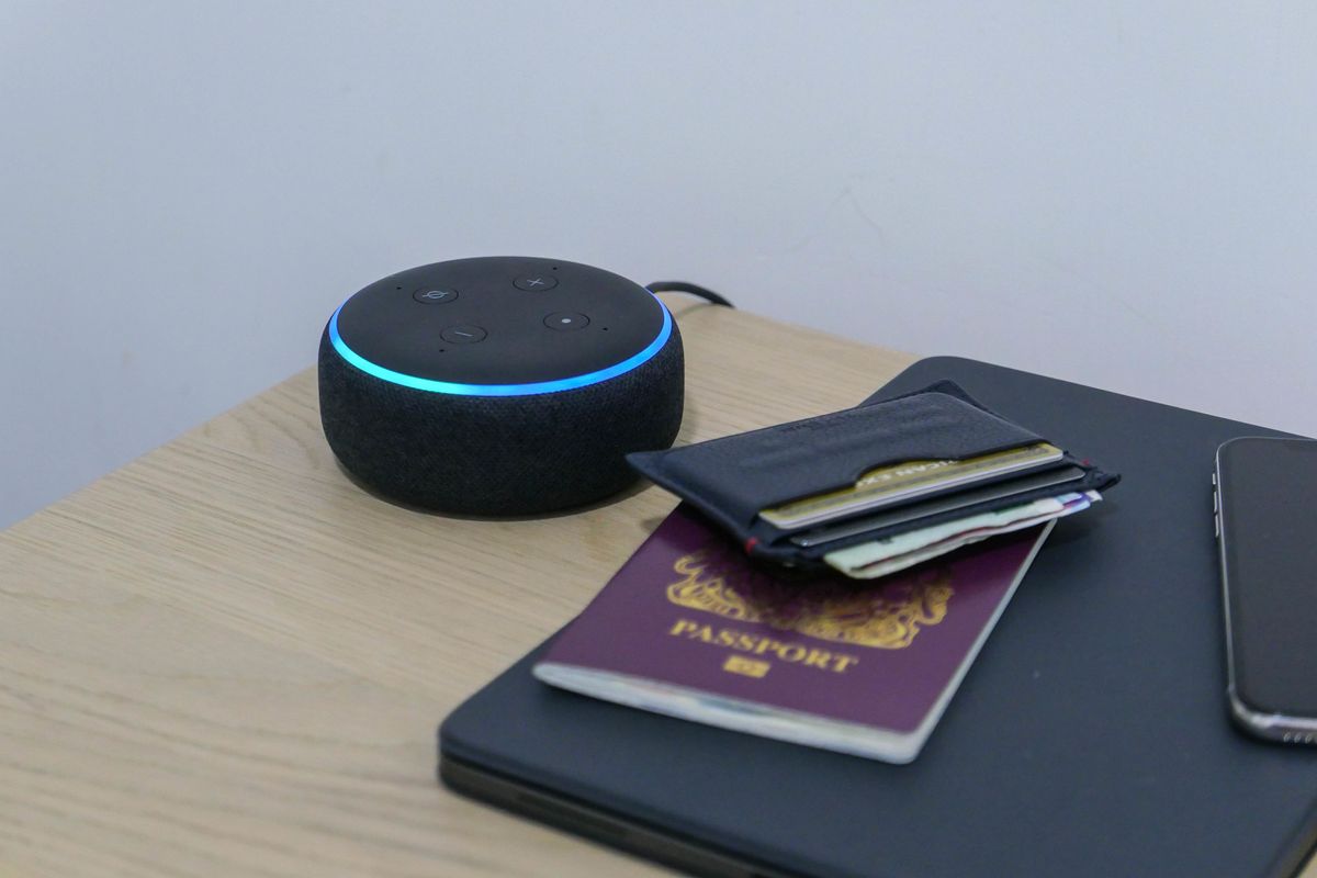 Photo of an Amazon Echo Dot on a hotel bedside table