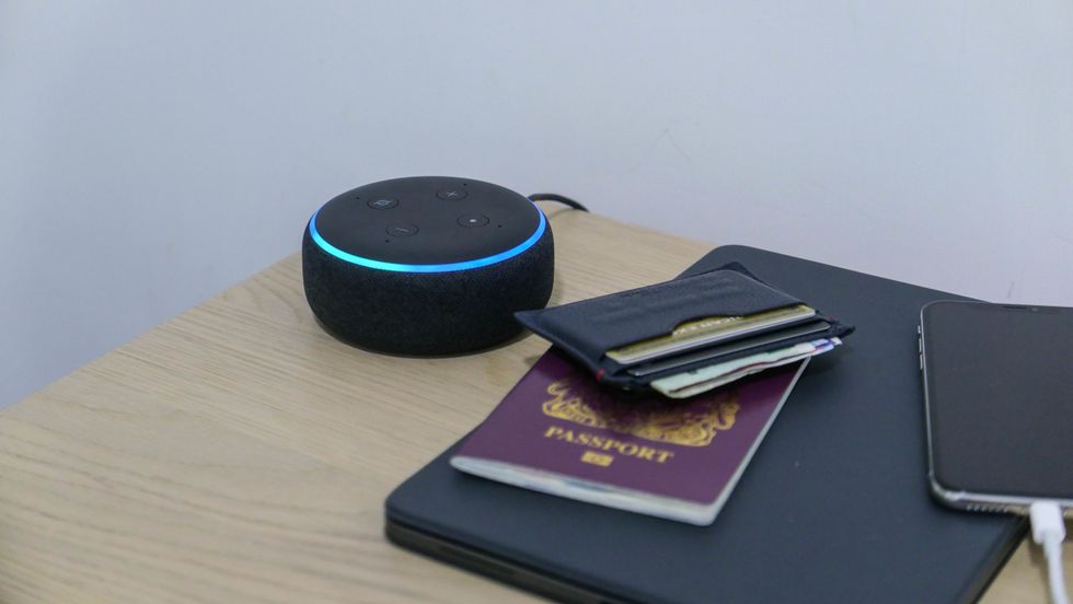 Photo of an Amazon Echo Dot on a hotel bedside table